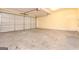 Spacious two car garage featuring painted walls and a concrete floor at 1716 Anniston Dr, Mcdonough, GA 30253