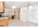 Well-lit kitchen featuring tile floors, wooden cabinetry, stainless steel appliances, and a door to the outside at 1716 Anniston Dr, Mcdonough, GA 30253