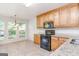 Eat-in kitchen featuring granite countertops, black appliances, and a view of the backyard at 1716 Anniston Dr, Mcdonough, GA 30253