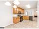 Well-equipped kitchen showcasing tile floors, wooden cabinets, modern appliances, and ample counter space at 1716 Anniston Dr, Mcdonough, GA 30253