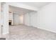 Bright, open-concept living area with tile floors leading to a carpeted space and cozy brick fireplace at 1716 Anniston Dr, Mcdonough, GA 30253