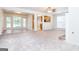 Bright, spacious living area featuring tile flooring, natural light, and seamless connectivity to the kitchen at 1716 Anniston Dr, Mcdonough, GA 30253