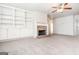 Bright and airy living room with carpet floors, a brick fireplace, and built-in shelving for ample storage at 1716 Anniston Dr, Mcdonough, GA 30253