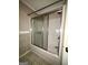 Bathroom showcasing a tub and shower combination, complete with glass sliding doors at 9163 Fair Sw St, Covington, GA 30014