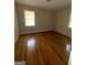 Comfortable bedroom features hardwood flooring, window, and neutral colored walls at 9163 Fair Sw St, Covington, GA 30014