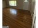 Bright living room featuring hardwood floors, a large window, and neutral paint at 9163 Fair Sw St, Covington, GA 30014