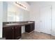 Bright bathroom with double sink vanity, neutral tile floors, and a large mirror with Hollywood-style lighting at 1281 Heartwood Ave, Mcdonough, GA 30253