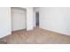 Neutral-toned bedroom with carpet flooring, closet, and access to another room at 1281 Heartwood Ave, Mcdonough, GA 30253