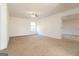 Large carpeted bedroom with a ceiling fan and a door leading to another room at 1281 Heartwood Ave, Mcdonough, GA 30253