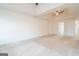 Large bedroom with carpet, a tray ceiling, and an open doorway to another room at 1281 Heartwood Ave, Mcdonough, GA 30253