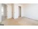 Modest bedroom with neutral carpet, double doors, and a closet with shelving at 1281 Heartwood Ave, Mcdonough, GA 30253
