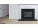 Close up of a fireplace, featuring a black firebox and white mantel at 1281 Heartwood Ave, Mcdonough, GA 30253