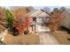Charming two-story brick home featuring a well-maintained lawn and mature trees at 1281 Heartwood Ave, Mcdonough, GA 30253