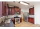 Well-lit kitchen featuring dark cabinets, stainless steel appliances and tile flooring at 1281 Heartwood Ave, Mcdonough, GA 30253