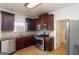Bright kitchen featuring stainless steel appliances and dark wood cabinets at 1281 Heartwood Ave, Mcdonough, GA 30253