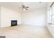 Spacious living room with a cozy fireplace and large windows for ample natural light at 1281 Heartwood Ave, Mcdonough, GA 30253