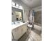 Bright bathroom featuring a large mirror and shower with tiled walls at 104 Hillmont Dr, Woodstock, GA 30188