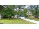 Charming single-Gathering home with a landscaped yard and two-car garage, surrounded by mature trees at 104 Hillmont Dr, Woodstock, GA 30188