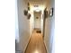 Hallway with laminate flooring, neutral walls, and decorative wall art at 104 Hillmont Dr, Woodstock, GA 30188