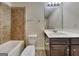 This bathroom features a shower and tub combo with tile surround, and a vanity with a white countertop at 749 Rolling Downs Dr, Loganville, GA 30052