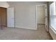 Bedroom features plush carpeting, a large window, and ample closet space at 749 Rolling Downs Dr, Loganville, GA 30052