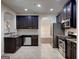 The kitchen has stainless steel appliances, dark cabinets, and granite countertops at 749 Rolling Downs Dr, Loganville, GA 30052