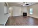Comfortable living room with a fireplace, hardwood floors, and plenty of natural light at 749 Rolling Downs Dr, Loganville, GA 30052