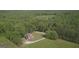 Aerial view of home nestled in a forest, surrounded by lush trees and greenery at 800 Attaway Rd, Bowdon, GA 30108