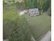 Aerial view of the home showing the spacious lawn, trees, and parking for multiple vehicles at 800 Attaway Rd, Bowdon, GA 30108