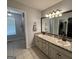 Bathroom featuring double sinks, framed mirror, and tile floor, with a shower and closet visible at 800 Attaway Rd, Bowdon, GA 30108