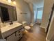 Bathroom with light gray walls, wood flooring and a white vanity at 800 Attaway Rd, Bowdon, GA 30108