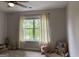 Bedroom with carpet, a ceiling fan, window with curtains and a reading nook with toys and books at 800 Attaway Rd, Bowdon, GA 30108