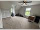 Open carpeted bonus room with natural light, a ceiling fan, and an office area at 800 Attaway Rd, Bowdon, GA 30108