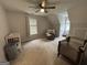 Large bedroom with carpet floors, ceiling fan, two windows, a crib and baby changing station at 800 Attaway Rd, Bowdon, GA 30108