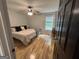 Bedroom with natural light, ceiling fan, wood floor, and black and white bedding set at 800 Attaway Rd, Bowdon, GA 30108