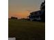 Charming home featuring a front porch, well-maintained lawn, and idyllic sunset at 800 Attaway Rd, Bowdon, GA 30108
