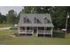 Picture of home with charming front porch, manicured lawn, and dormer windows at 800 Attaway Rd, Bowdon, GA 30108