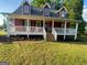 Charming red home with a welcoming front porch and well-maintained lawn at 800 Attaway Rd, Bowdon, GA 30108