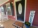Inviting front door and rocking chairs on the porch add cozy charm at 800 Attaway Rd, Bowdon, GA 30108