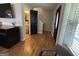 Hallway featuring wood floors, a powder room, a staircase and natural light coming through a window at 800 Attaway Rd, Bowdon, GA 30108