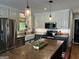 Beautiful kitchen featuring stainless steel appliances, a farmhouse sink, and a wooden island at 800 Attaway Rd, Bowdon, GA 30108