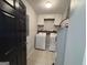 Functional laundry room with modern washer, dryer, and ample cabinet space at 800 Attaway Rd, Bowdon, GA 30108