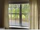 View of a lush green space through a window with curtains, providing natural light and privacy at 800 Attaway Rd, Bowdon, GA 30108