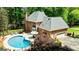 Aerial view of brick home with an in-ground pool, mature trees, and ample yard space at 255 Emerald Lake Dr, Fayetteville, GA 30215