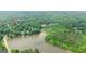 A vast lake surrounded by dense, green forests with a neighborhood nearby at 255 Emerald Lake Dr, Fayetteville, GA 30215