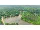 A scenic view of a lake surrounded by dense forests with a nearby neighborhood at 255 Emerald Lake Dr, Fayetteville, GA 30215