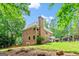 Beautiful brick home with bay window, mature trees, and professionally landscaped backyard at 255 Emerald Lake Dr, Fayetteville, GA 30215
