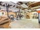 Unfinished basement with exposed piping, concrete flooring, and a work station at 255 Emerald Lake Dr, Fayetteville, GA 30215