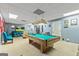 Finished basement featuring a pool table, turquoise couch, and decorations at 255 Emerald Lake Dr, Fayetteville, GA 30215