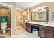 Bathroom featuring a glass shower, vanity with a makeup counter, and beige tile flooring at 255 Emerald Lake Dr, Fayetteville, GA 30215